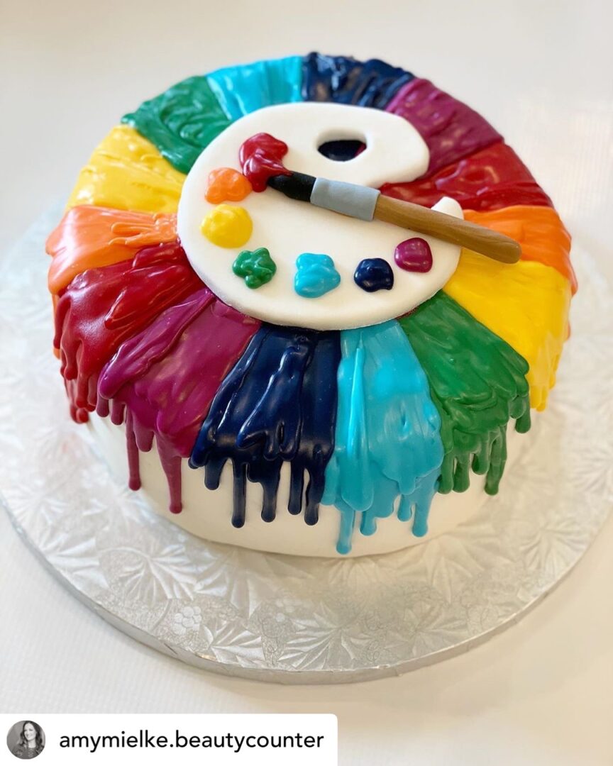 Cake with rainbow colors and paint board