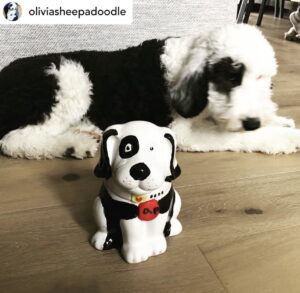 a real dog and a dog figurine