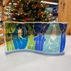 Curved glass artwork depicting three figures with cracked surface effect.