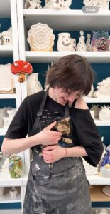 Person lovingly holding and cuddling a cat indoors.